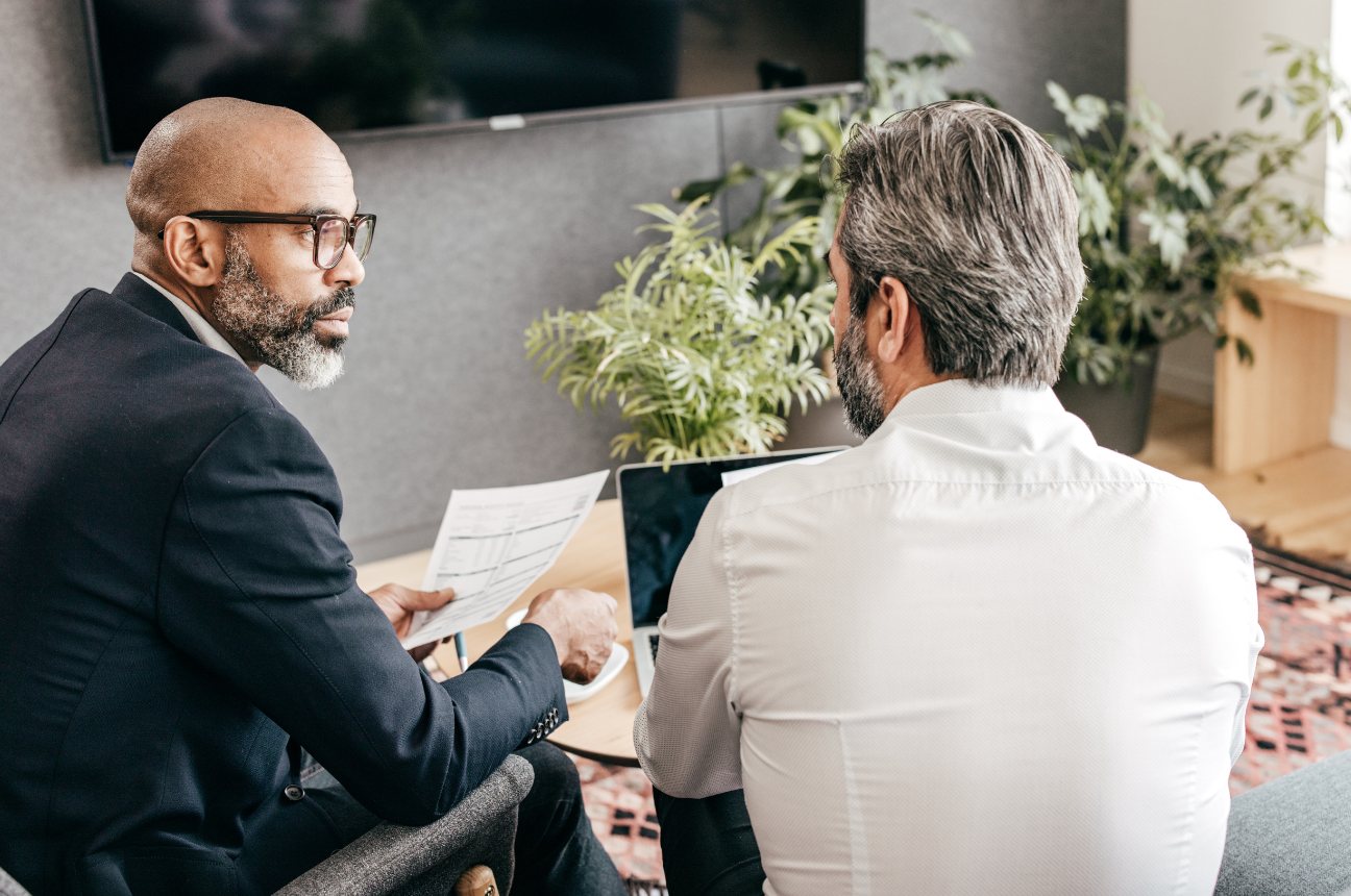 Two professionals reviewing a printed document